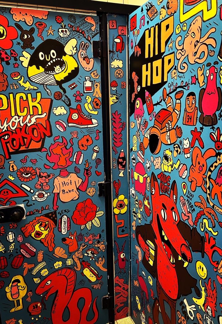 
Kabinentoiletten des Gymnasiums Schloss Hagerhof, komplett mit detailreichen blau-roten Doodle-Illustrationen gestaltet
